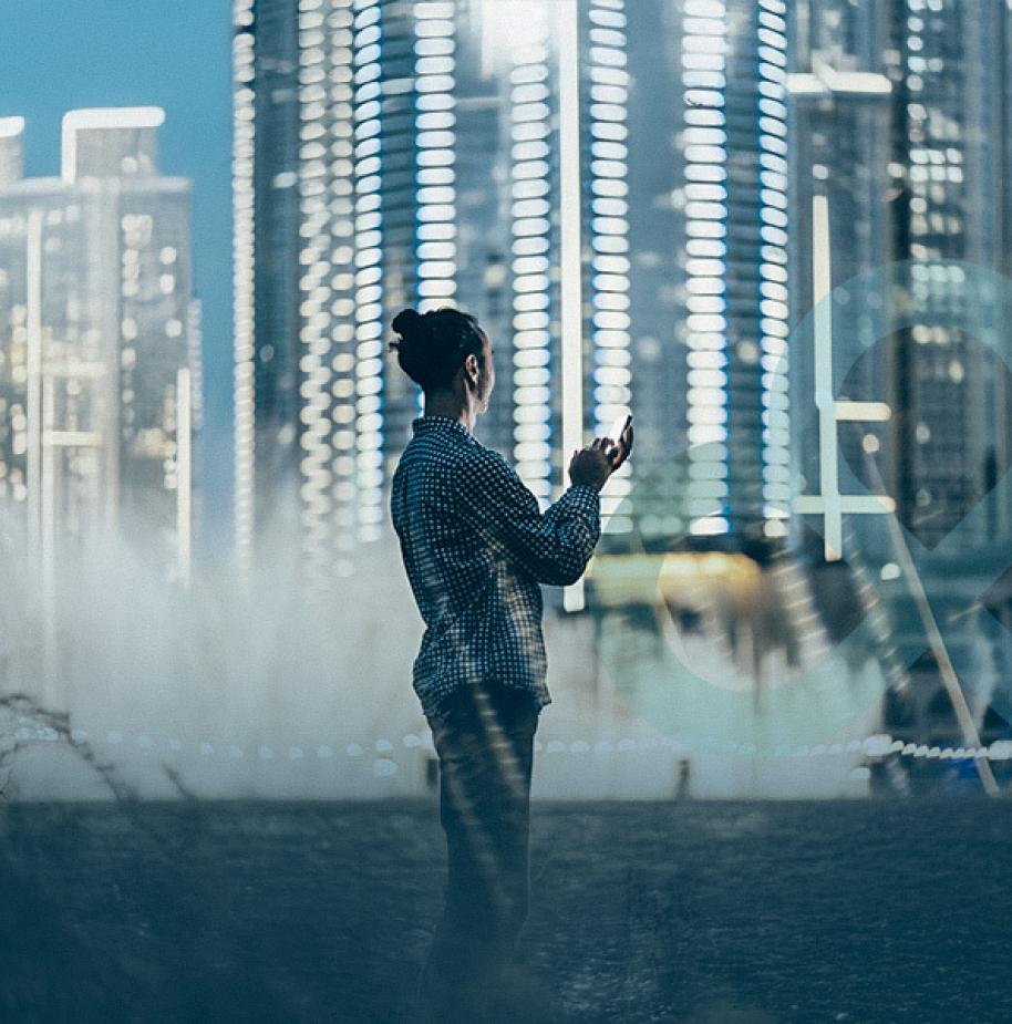 person using phone in front of cityscape