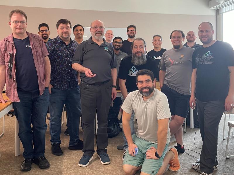 A group photo of the Developer U trainers and trainees, some wearing EDB shirts, or references to open source software.